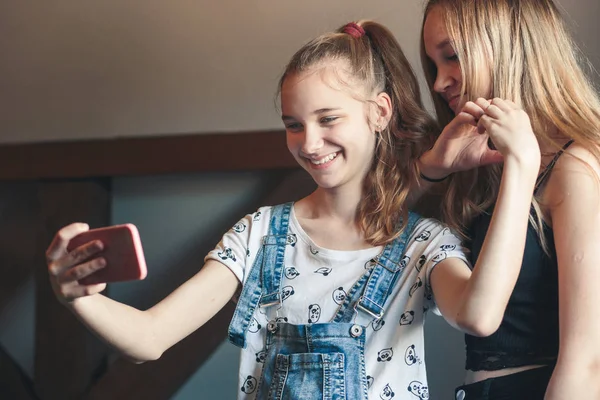 Молодые женщины делают селфи, используя камеру смартфона — стоковое фото