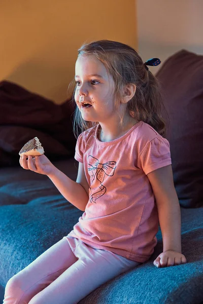 Little girl concentrated on watching TV