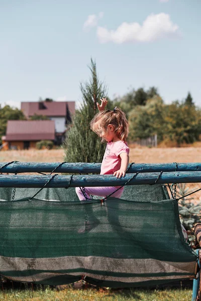 Little girl playing in a home playground — Stock Photo, Image