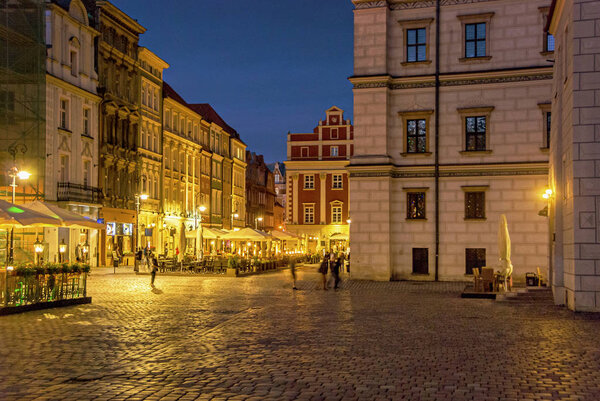 Old famous square market with restaurants and cafe in Poznan at night