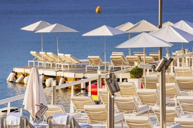 Cannes 'da yat tekneleri ve plaj şemsiyesi olan deniz Körfezi