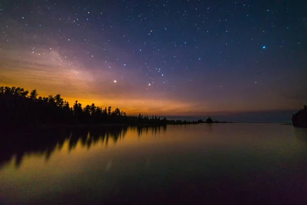 Moonrise and star reflections in night skynover Lake Huron