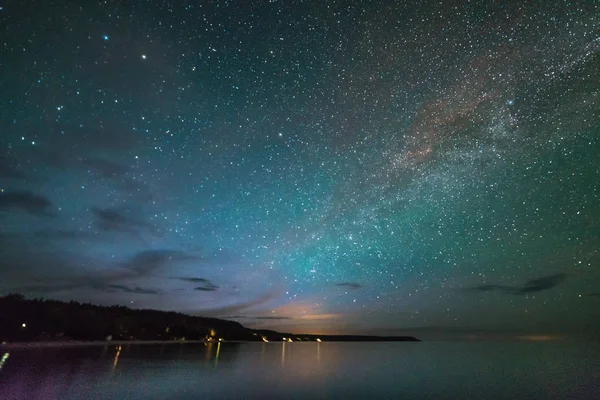 Voie lactée et étoiles au-dessus de l'eau la nuit — Photo