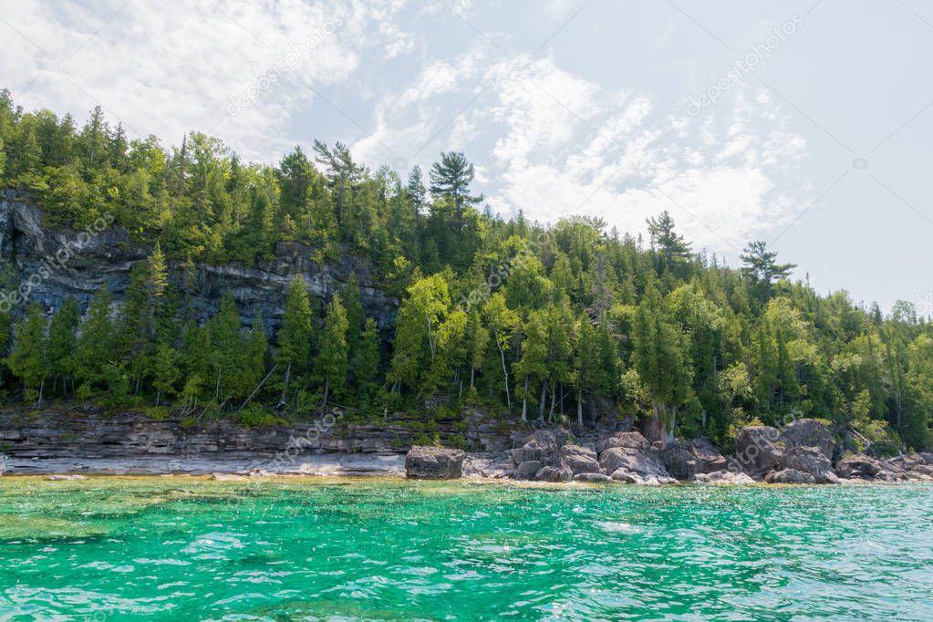 Bright beautiful landscape of Niagara Escarpment limestone cliffs along the blue lake huron shore