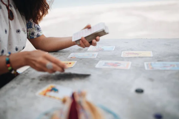 Woman is reading Tarot cards at the beach — Stock Photo, Image