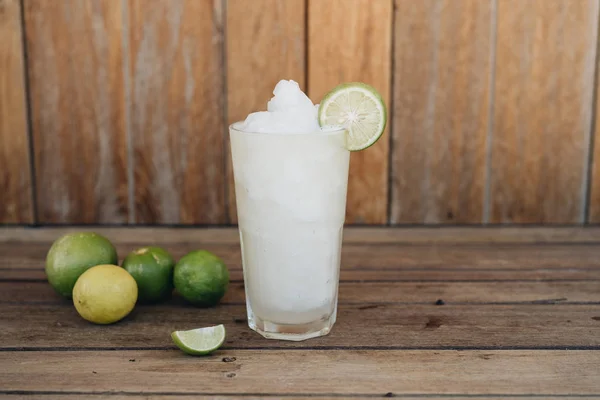 Lime shake in glass at wooden background — Stock Photo, Image