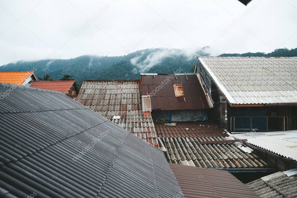 Roofs of houses in chinese street in old town koh Lnata, Thailand Cloudy day