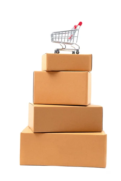 Shopping cart on brown parcels box — Stock Photo, Image