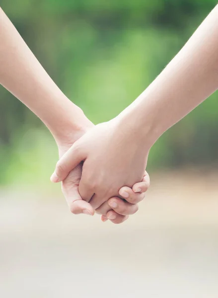 two asian woman holding hands