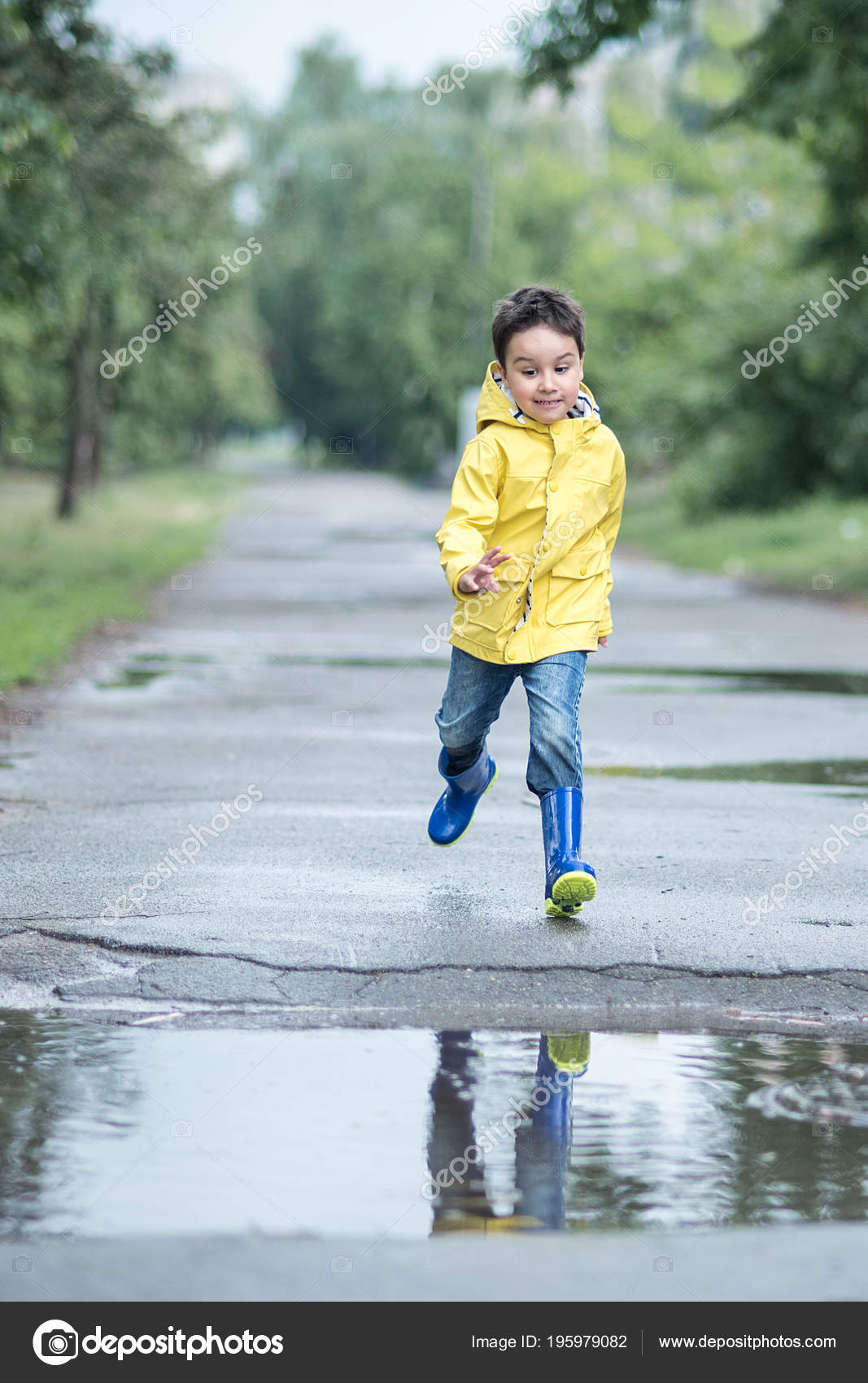 Little Boy Raincoat Rubber Boots Playing Puddle Stock Photo by ©serenko