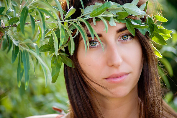 Summer lifestyle portrait of beautiful romantic girl holding bouquet of wild flowers.