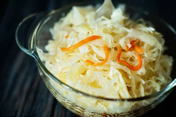 Salad homemade sauerkraut in a glass jar on a table — Stock Photo, Image