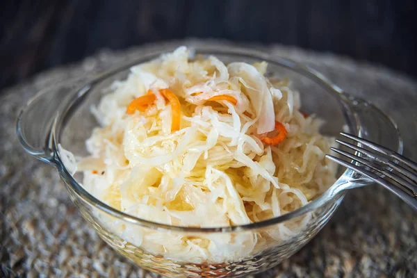 Salad homemade sauerkraut in a glass jar on a table — Stock Photo, Image