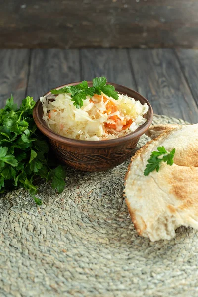 Salad homemade sauerkraut in a glass jar on a table — Stock Photo, Image