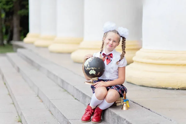 Happy Schoolgirl White Bows Hair Holding Globe While Sitting Stairs — Stock Photo, Image