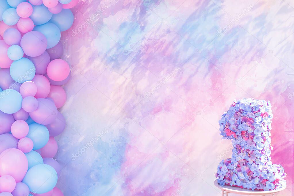 first birthday decoration and colorful balloons on punchy pastel colored background 