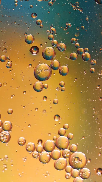 oil with bubbles on color background. Abstract space background. Soft selective focus. macro of oil drops on water surface. copy space. air bubbles in water. Vertical format, social media ready