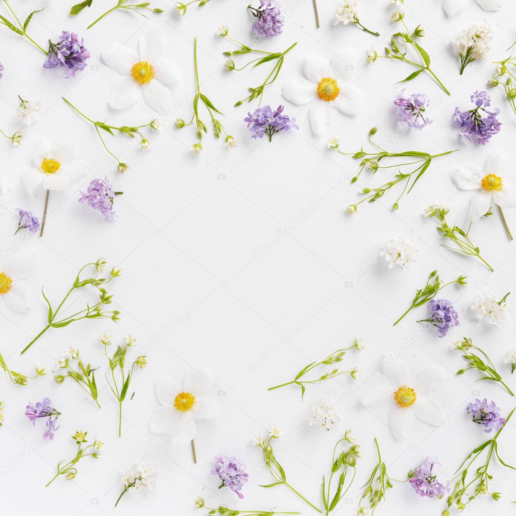 Floral composition with lilac, white wildflowers and jasmine on white background 