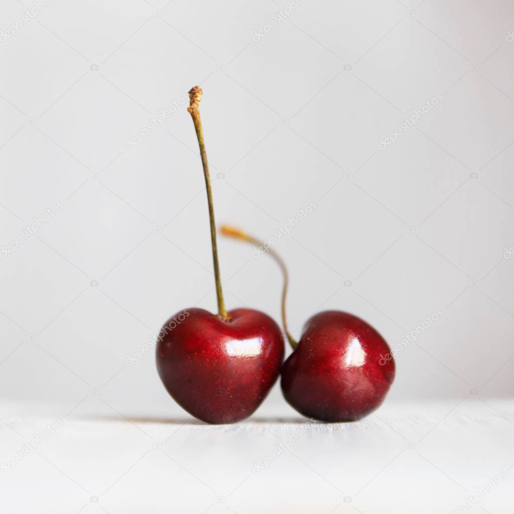 Close view of ripe sweet cherries on grey background