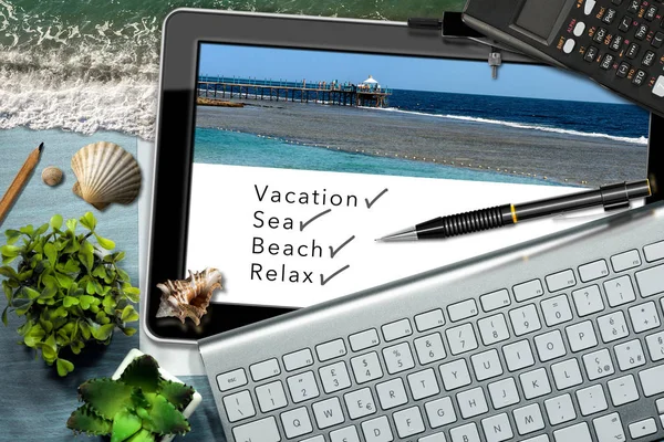 Dreaming summer vacation at work. Workspace with tablet computer, keyboard, calculator, sea waves, seashells and texts, Vacation, Sea, Beach and Relax