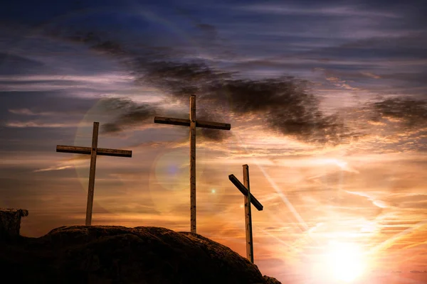 Three crosses on a dramatic sky at sunset