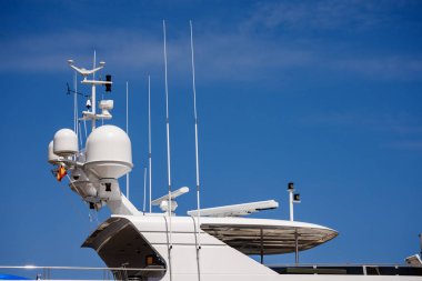 Ayrıntılı bir beyaz lüks yat seyir cihazları, radar ve mavi gökyüzü, antenler ile üst yapı