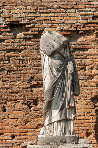 Headless roman statue with toga - Ostia Antica Rome Italy