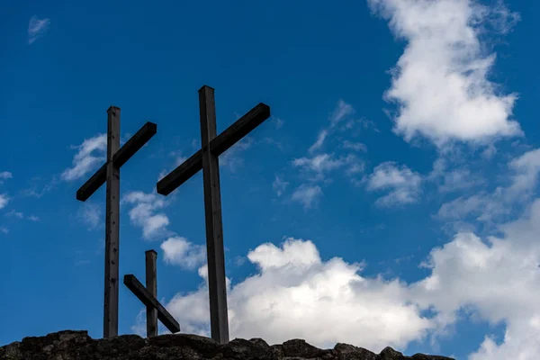 Drie Christelijke kruisen op blauwe hemel met wolken — Stockfoto