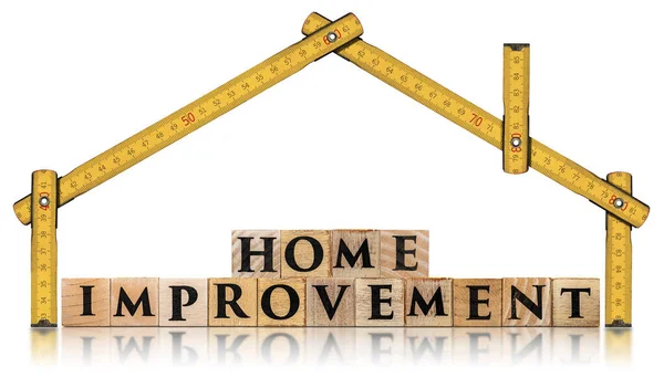 Yellow wooden folding ruler in the shape of a house and the text Home Improvement, made of wooden blocks, isolated on white background