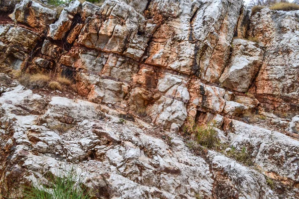 Texture of the rock. Large rocks exfoliate from the rock.