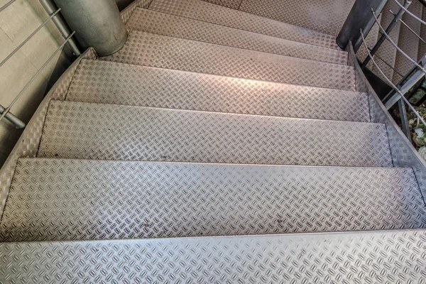 Metal staircase. Steps from light metal with a covering against sliding.