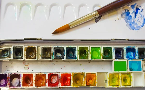 Set of watercolor paints and paintbrushes for painting closeup. Selective focus. — Stock Photo, Image