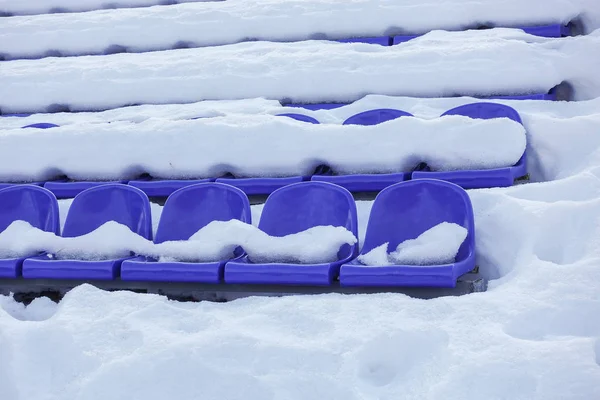 Arquibancadas de estádio de esportes no inverno, cadeiras dos torcedores - assentos vazios de arquibancadas cobertas de neve — Fotografia de Stock