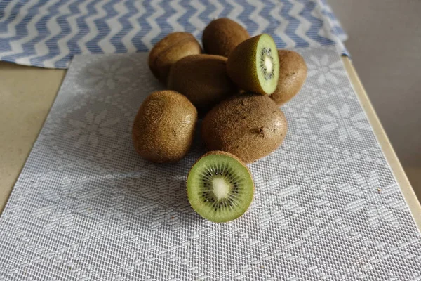 Φρέσκο ακτινίδιο φρούτων στο τραπέζι. Ολόκληρα και κομμένα — Φωτογραφία Αρχείου