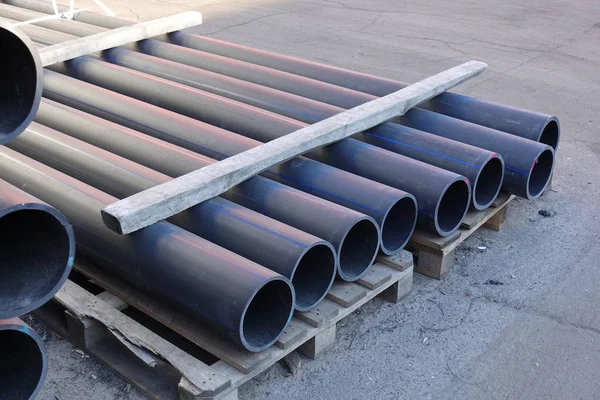 Plastic pipes in stock of finished products stacked in packs — Stock Photo, Image