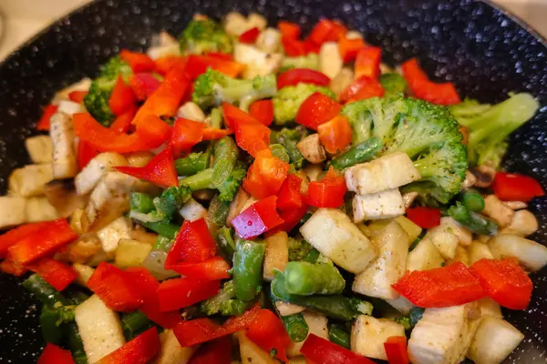 Gemüse in einer Pfanne gekocht. Champignons, Brokkoli, Paprika. Vegetarische Kost. das Konzept der gesunden Ernährung. — Stockfoto