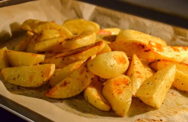 Fırında patates dilimleri fırında kağıt üzerinde. Close