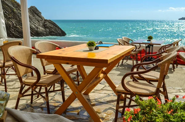 Table and chairs of the restaurant near the sea. Sunny day is summer. Without people. Montenegro