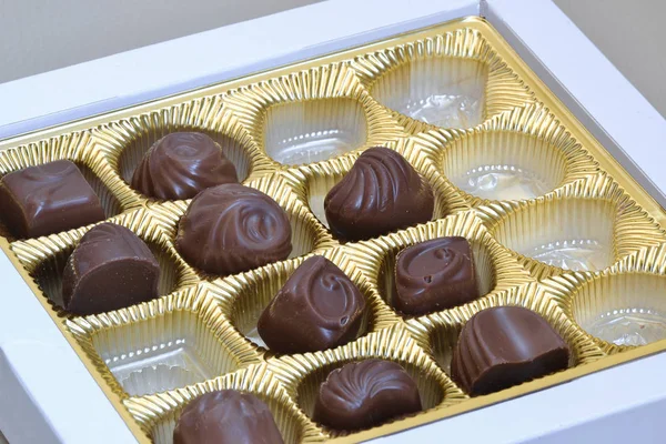 Chocolate candies in incomplete box — Stock Photo, Image