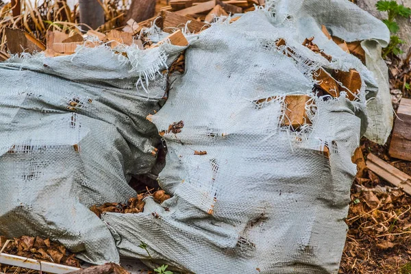 Firewood in an old hollow sack — Stock Photo, Image