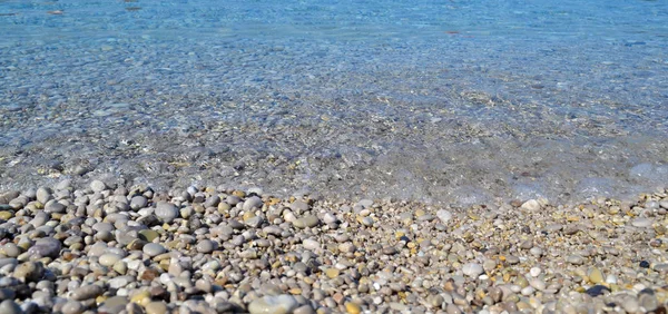 Astratto spiaggia sfondo texture con ciottoli, sabbia e acqua di mare in tacchino tamburo — Foto Stock