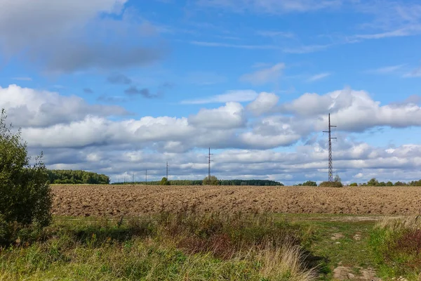 Plowed field and uncultivated land nearby. Agriculture — Stock Photo, Image