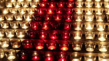  White and red glass candles light close up in church