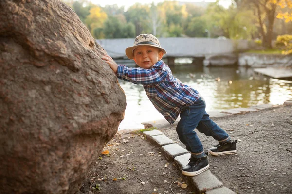 Menino Está Brincando Empurrando Uma Pedra Durante Passeio Parque Contra — Fotografia de Stock