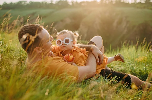 Молодой Отец Лежит Траве Обнимает Свою Дочь Время Прогулки Парке — стоковое фото
