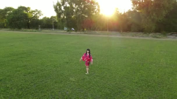 Japanese Ballerina Red Kimono Jumps Performs Gymnastic Twine Lawn Background — Stock Video