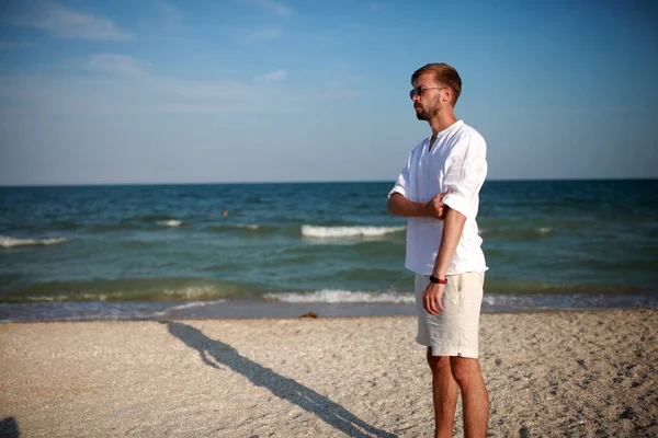 Hombre Joven Gafas Sol Encuentra Playa Sobre Fondo Del Mar — Foto de Stock