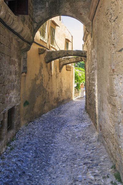 Historical street of old town Rhodes with archs in Rhodes, Dodecanese, Greece