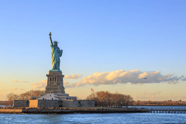 Statue of liberty horizontal during sunset in New York City, NY, USA