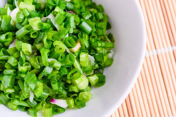 Freshly cut spring onion in bowl — Stock Photo, Image